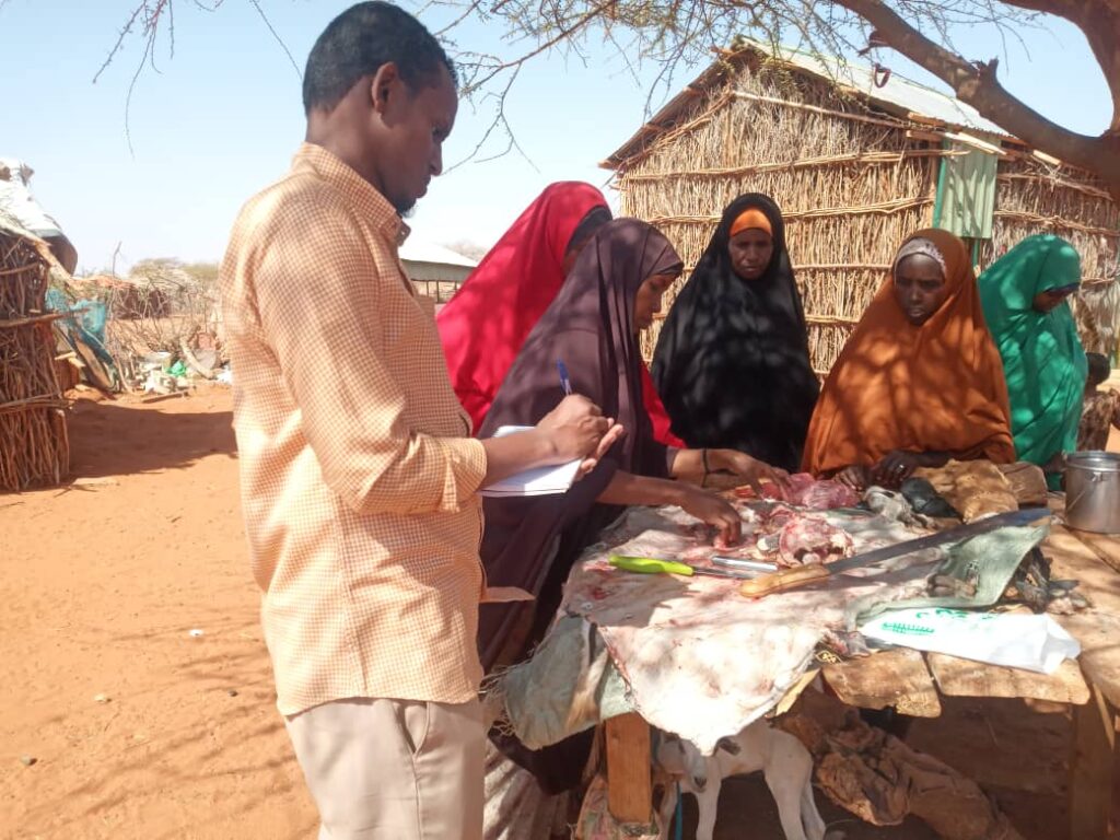 Maryam Mohamed Abdi with her children and Racida Project officer,Abdirahman Areys